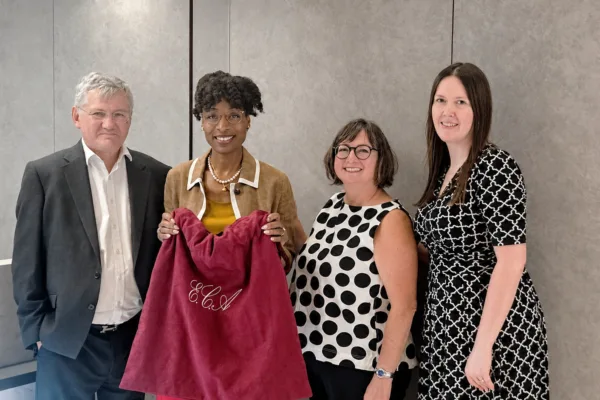 Ebony Alleyne presented with a red bag by Paul Reed KC